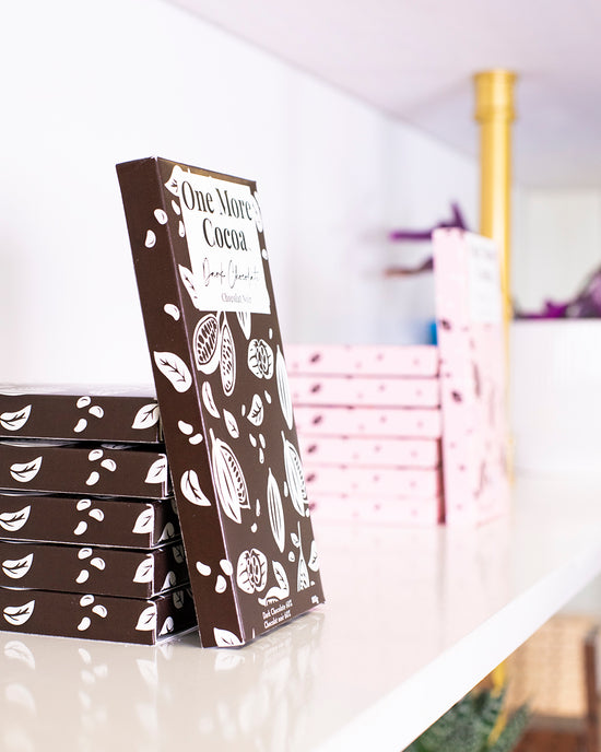 Stacks of gourmet chocolate bars on display in the One More Cocoa store