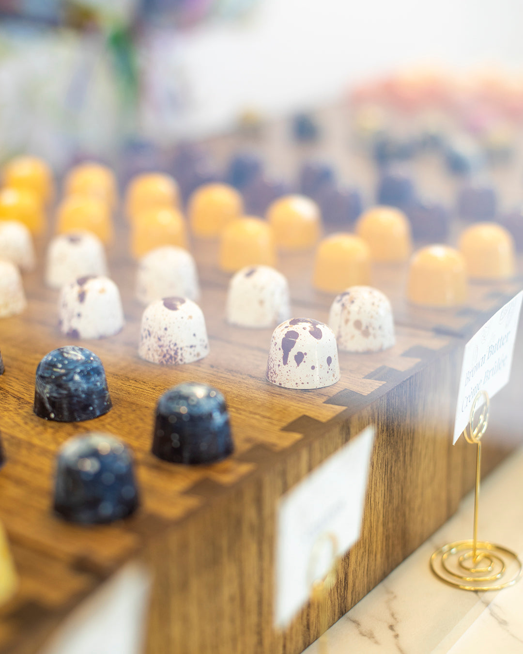 Lines of chocolate bonbons on display in the One More Cocoa store