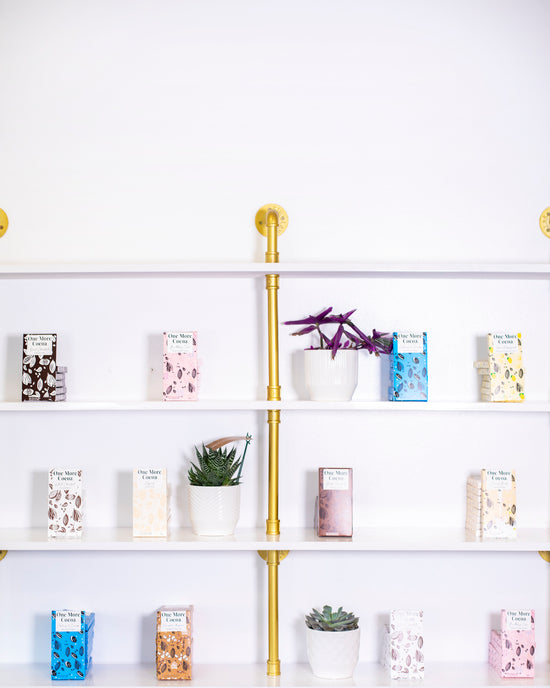 One More Cocoa store shelves with a variety of gourmet chocolate bars